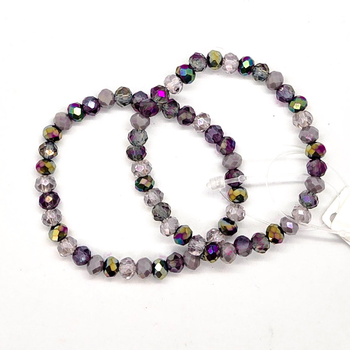 Beaded bracelet with multicolor purple beads on a white background