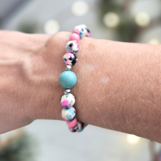 Blue & Pink Stretch bracelet on a blurred background