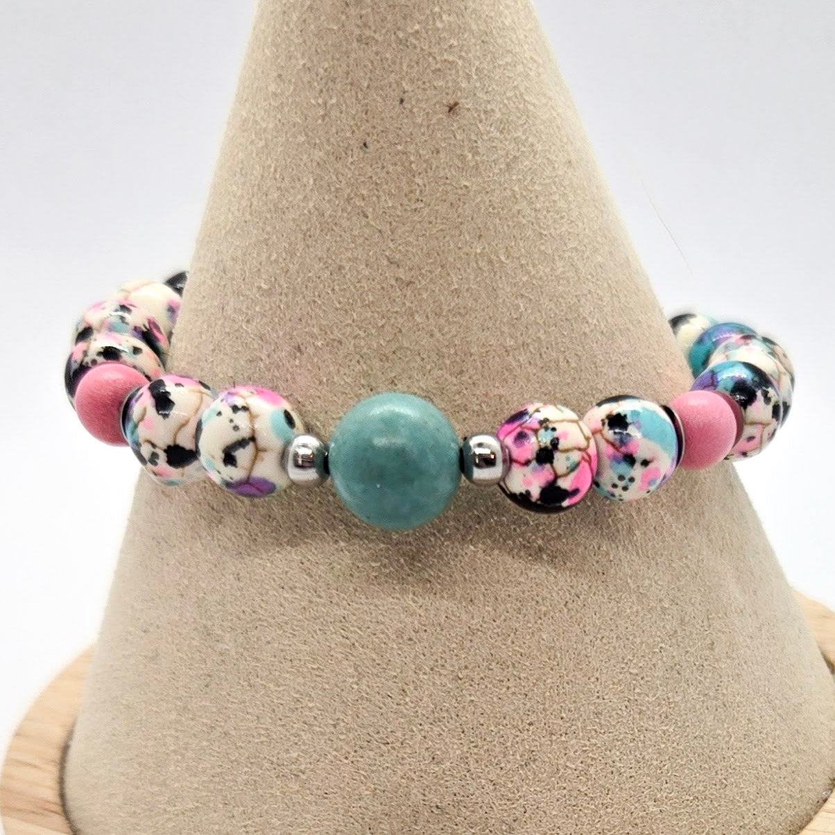 Blue and Pink bracelet on a beige stand