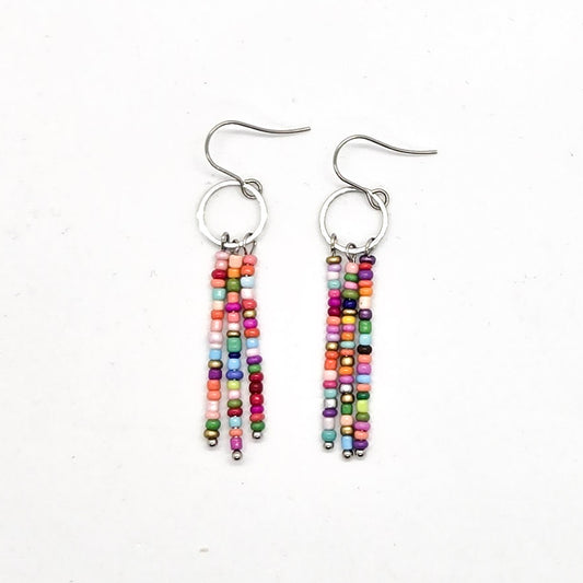 Colorful beaded fringe earrings on a white background